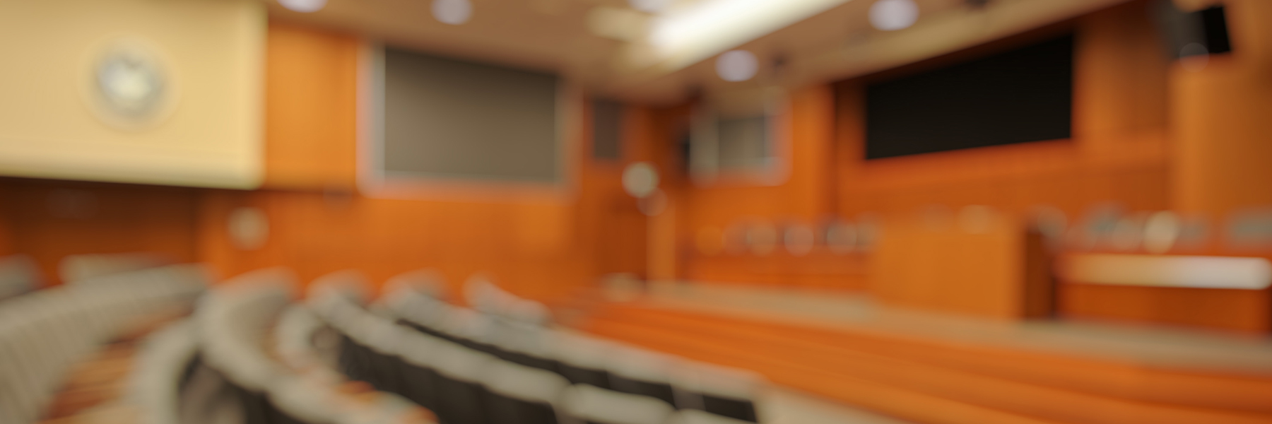 Blurred modern orange entertainment room or theater with professional audio visual equipment installation for home and business AV systems