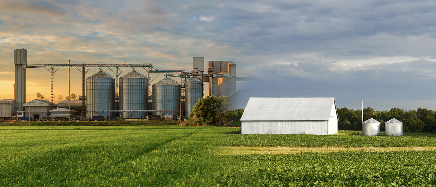 Agricultural grain processing facility with multiple silos conveyor systems and processing buildings at sunset professional electrical services for farming operations