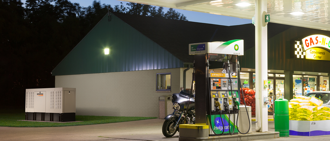 Generac commercial generator installed beside gas station with convenience store providing backup power for retail business operations