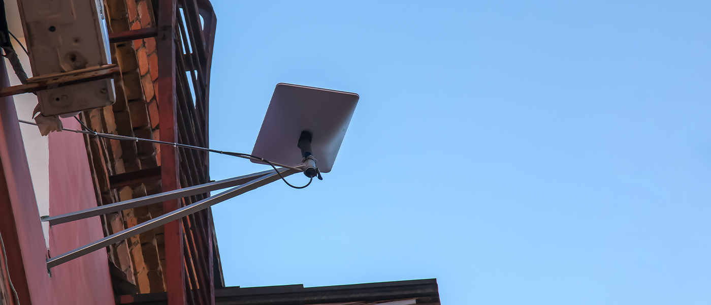 Starlink dishinstalled on the side of an apartment building